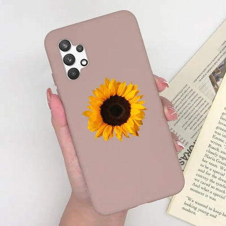 a woman holding a phone case with a sunflower on it