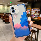 a person holding a phone case with a painting on it