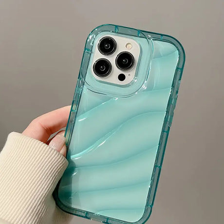 a person holding a phone case with a blue liquid