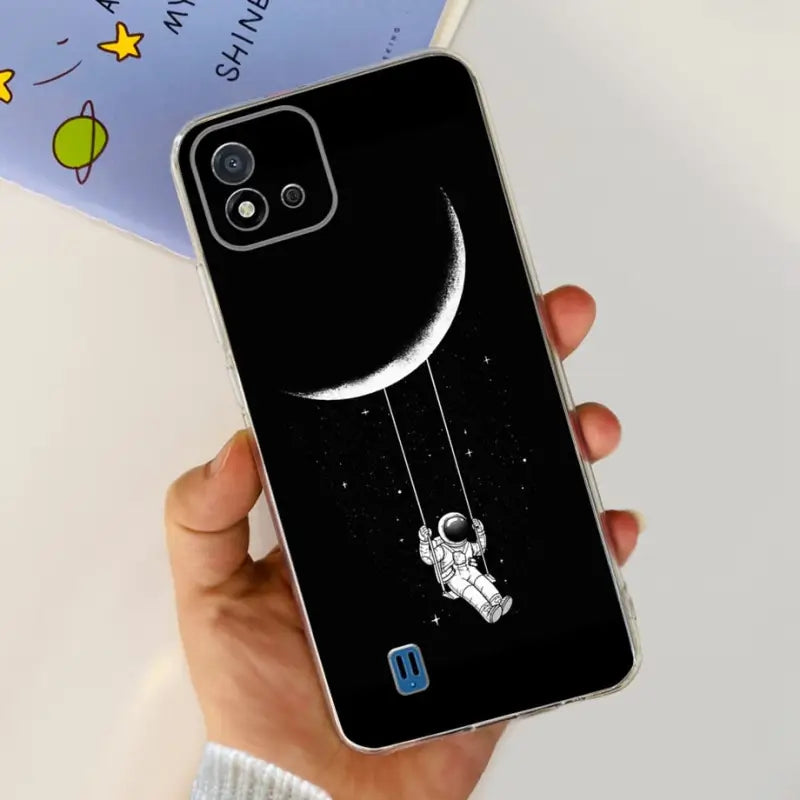a person holding a phone case with a drawing of an astronaut on it