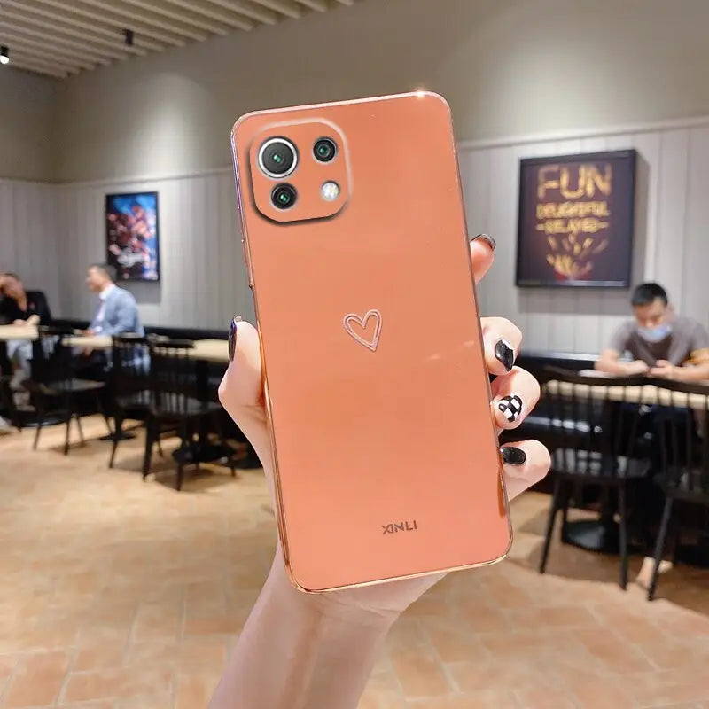 a person holding up a pink iphone case