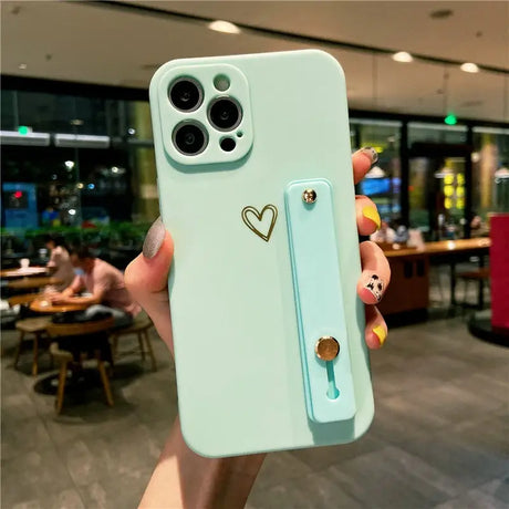 a person holding a phone case with a heart on it