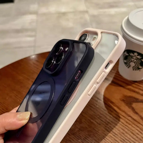 a woman holding a phone with a cup of coffee in the background