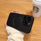 a person holding a phone with a cup of coffee in the background