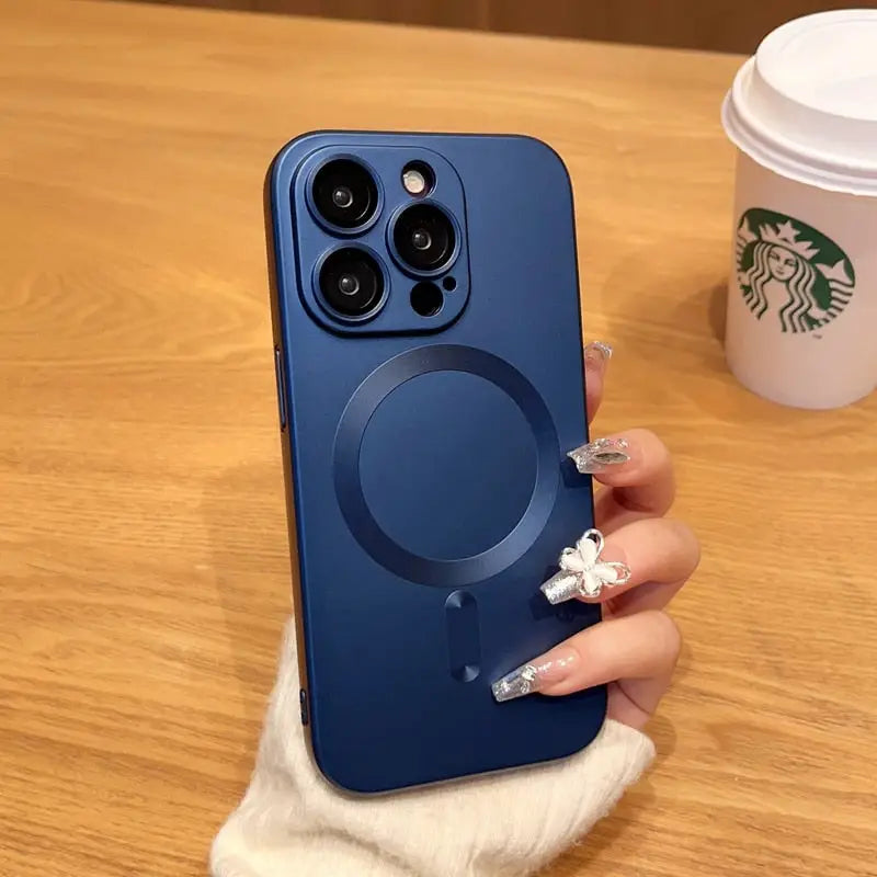a woman holding a phone with a cup of coffee in the background
