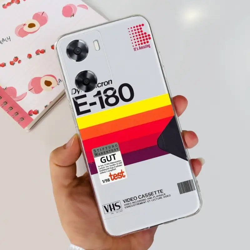 a hand holding a phone with a colorful design