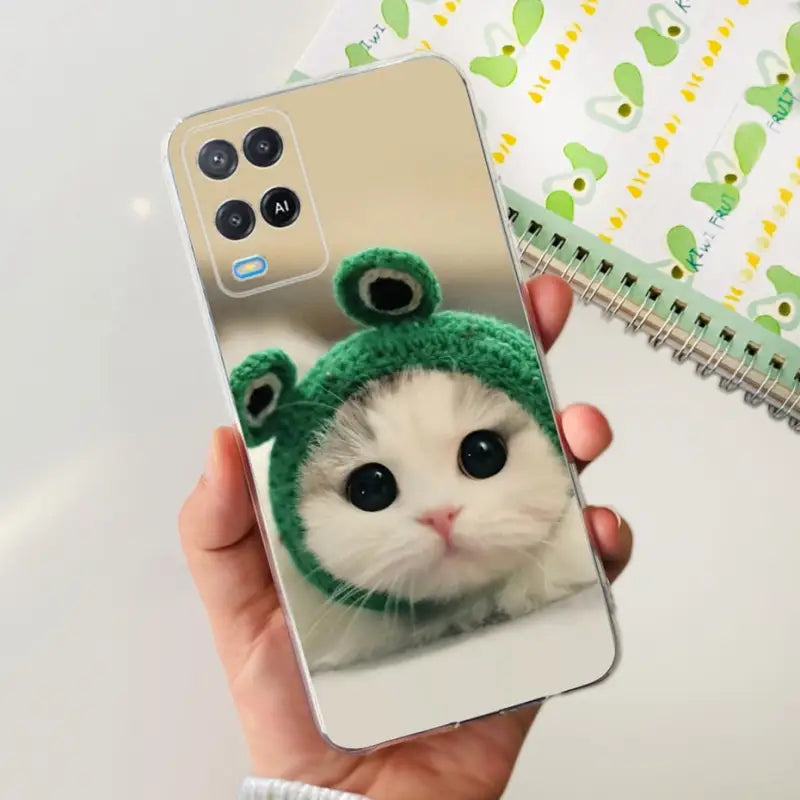 a person holding a phone with a cat in it