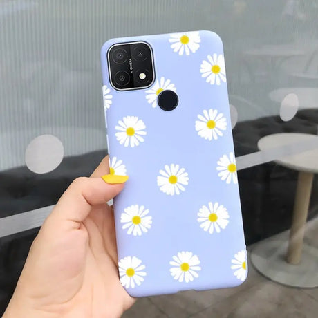 someone holding a phone case with a daisy pattern on it