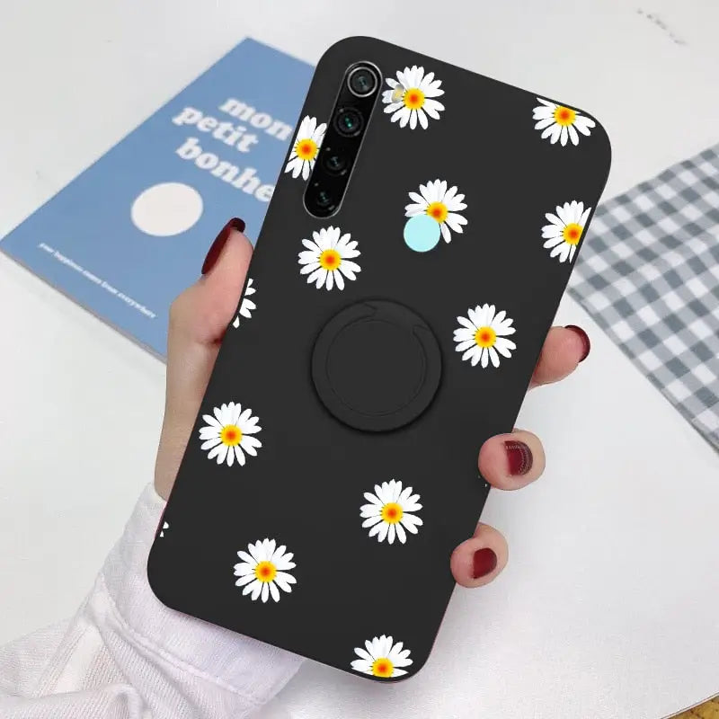 a person holding a phone with a flower pattern on it