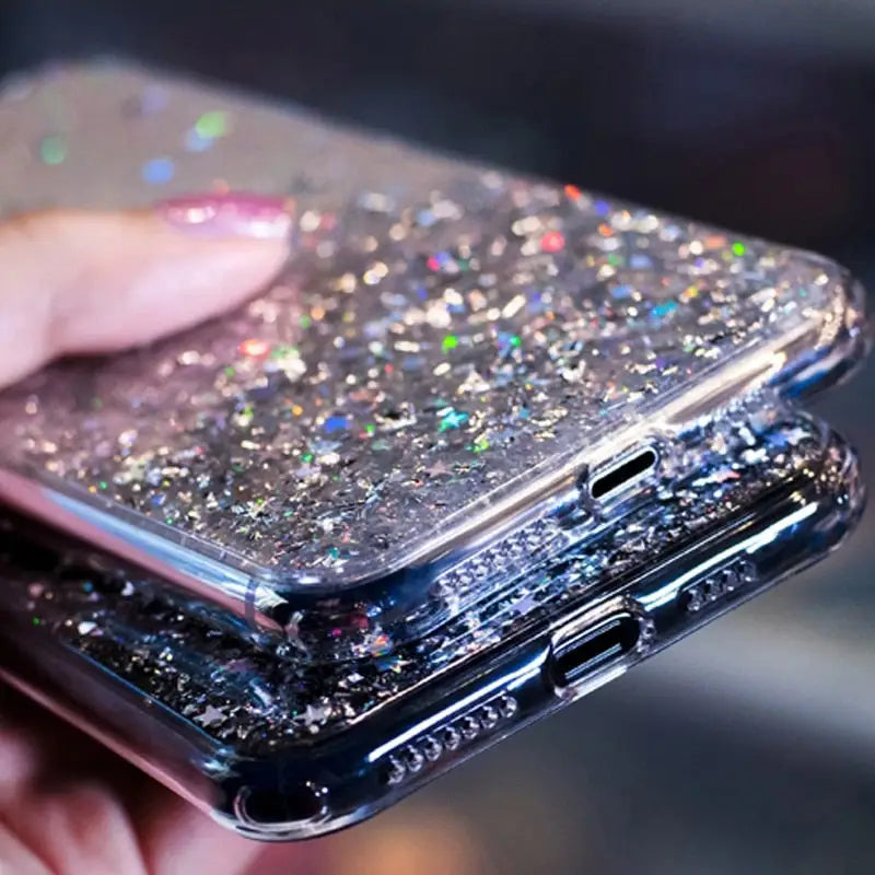 a person holding a phone with glitter on it