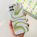 a person holding a phone with a green and white pattern