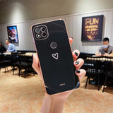 a person holding up a phone with a heart on it