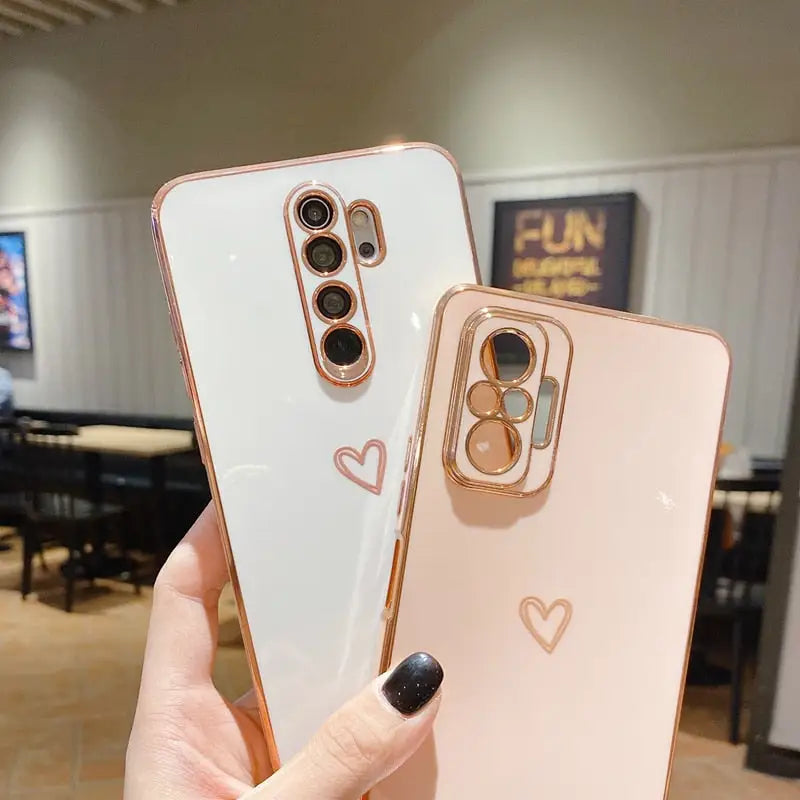 a person holding a phone with a heart on it