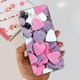 a person holding a phone with pink and purple hearts