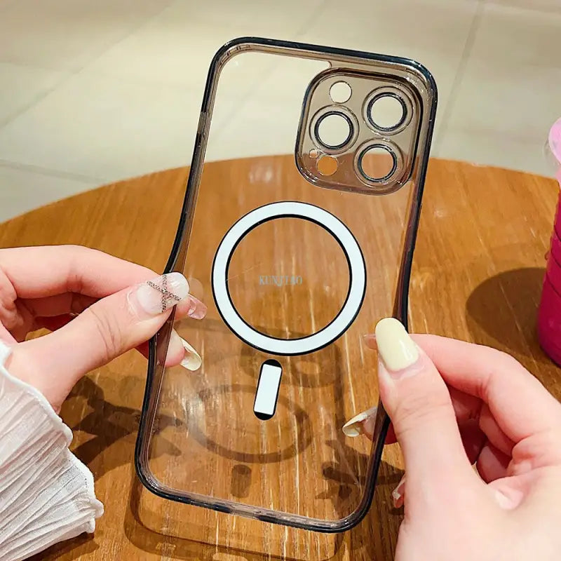a person holding a phone with a ring on it