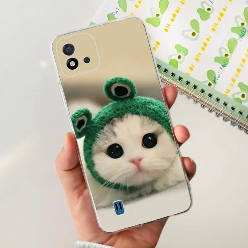 a person holding a phone with a cat in it