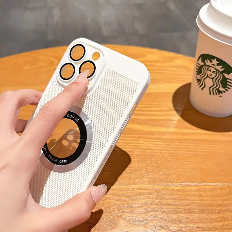 a hand holding a phone with a starbucks cup in the background