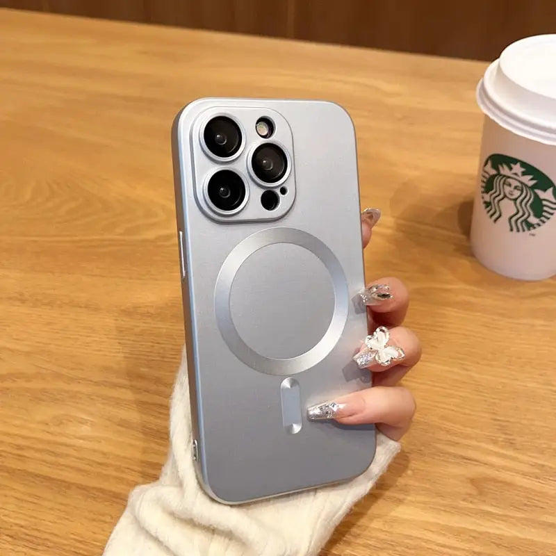 a woman holding a phone with a starbucks cup in the background