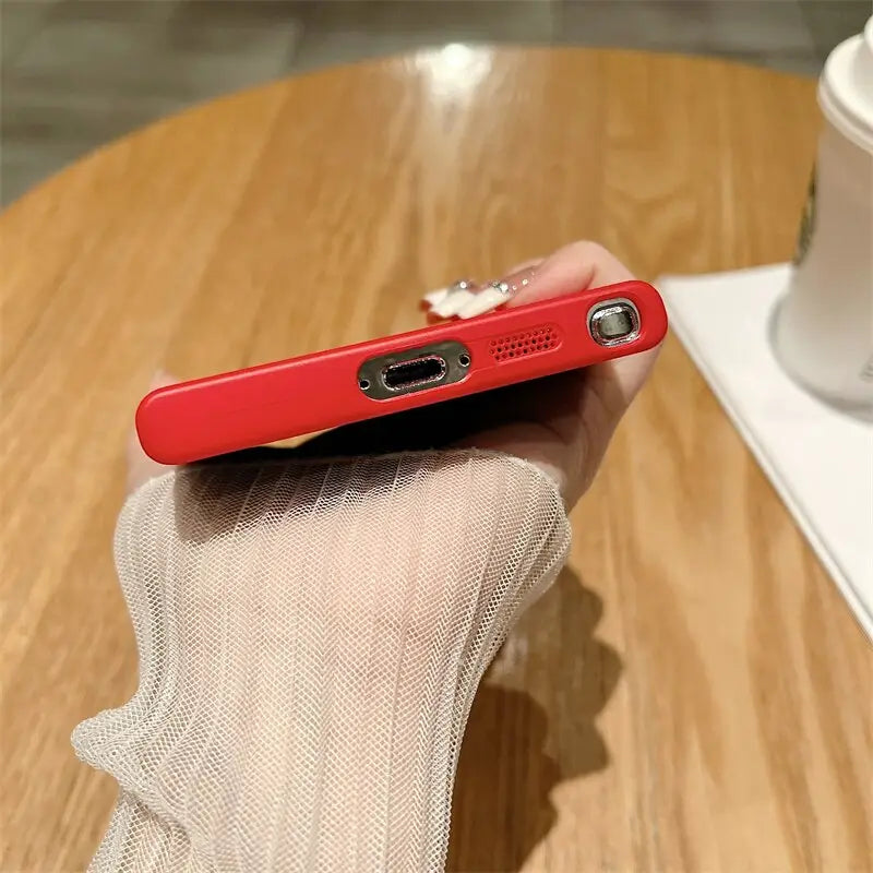 a person holding a red phone in their hand