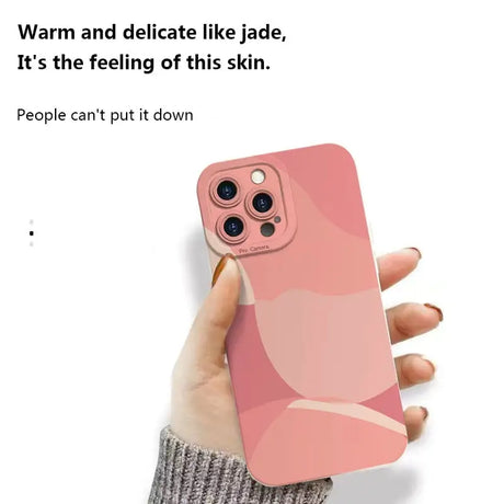 a woman holding a pink iphone case