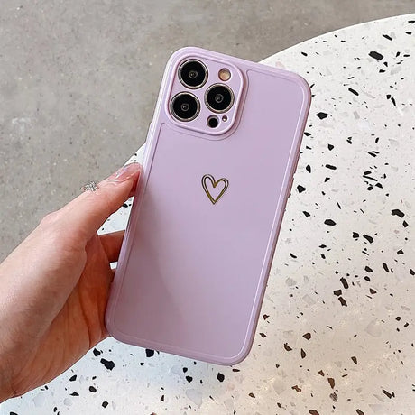 a person holding a pink iphone case