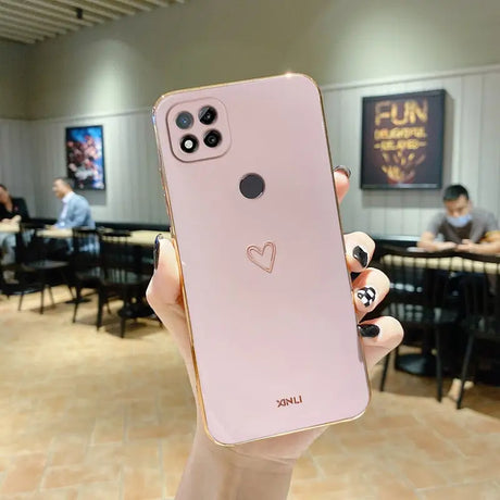 a person holding up a pink iphone case