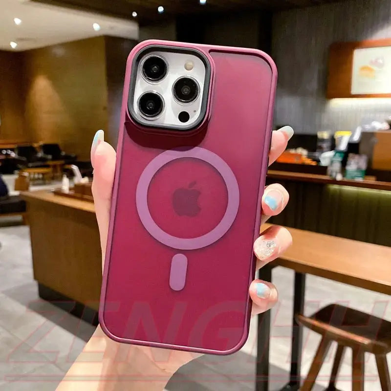 a woman holding up a pink iphone case