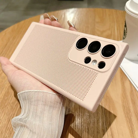 a hand holding a pink iphone case