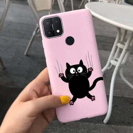 a person holding a pink phone case with a black cat on it