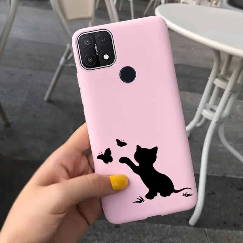 a person holding a pink phone case with a cat silhouette