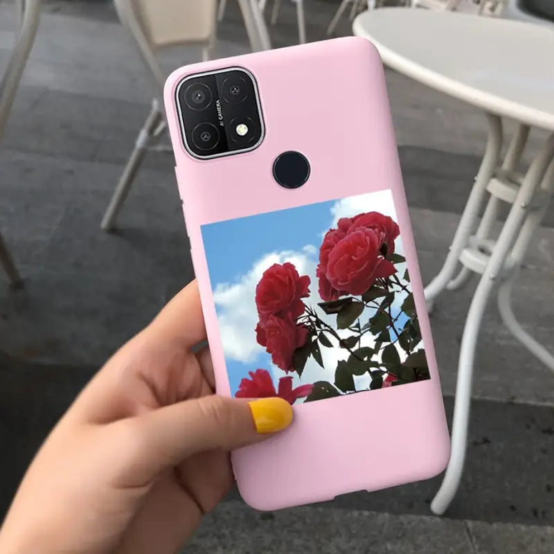 a person holding a pink phone case with a photo of a rose