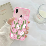 a person holding a pink phone case with a pink flower design