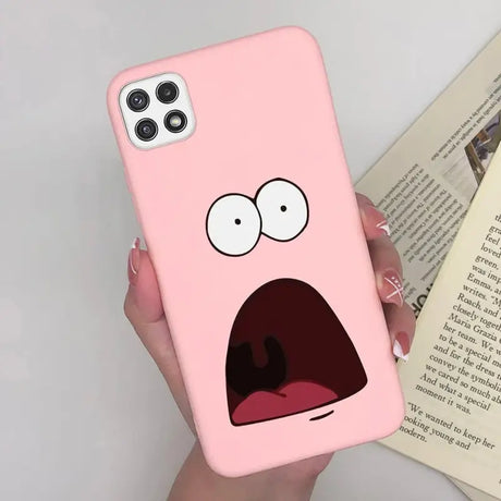 a pink phone case with a cartoon face on it