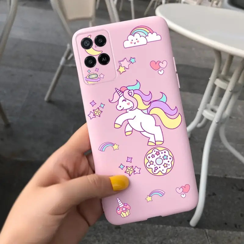 a person holding a pink phone case with unicorns and stars