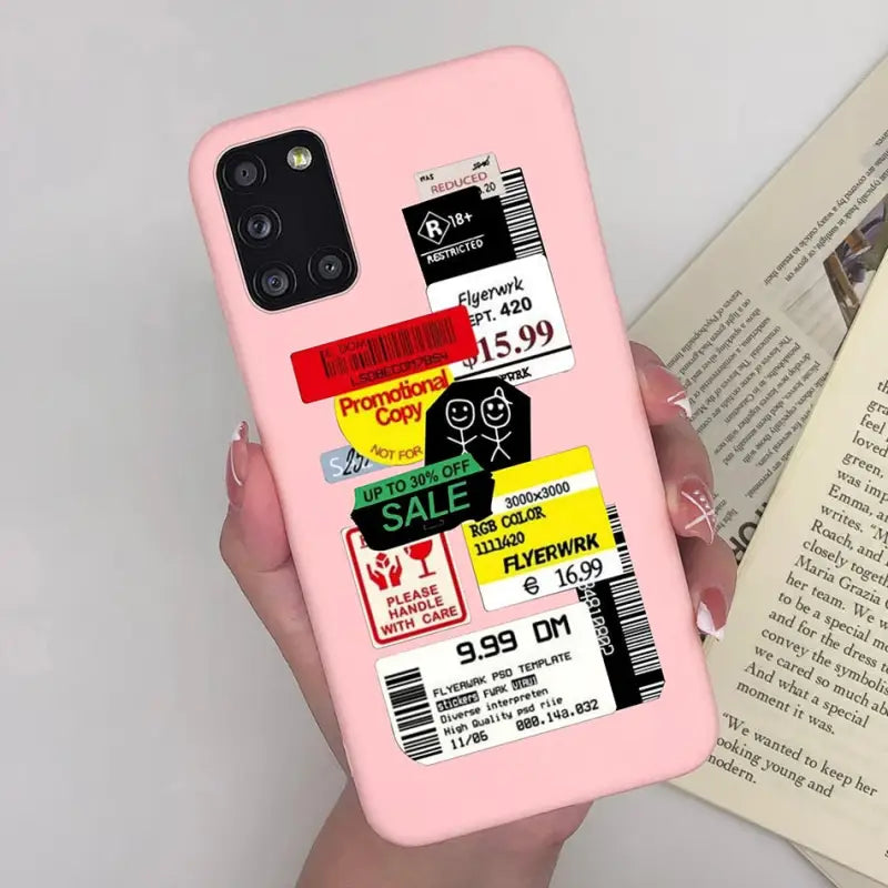 a person holding a pink phone case with a book