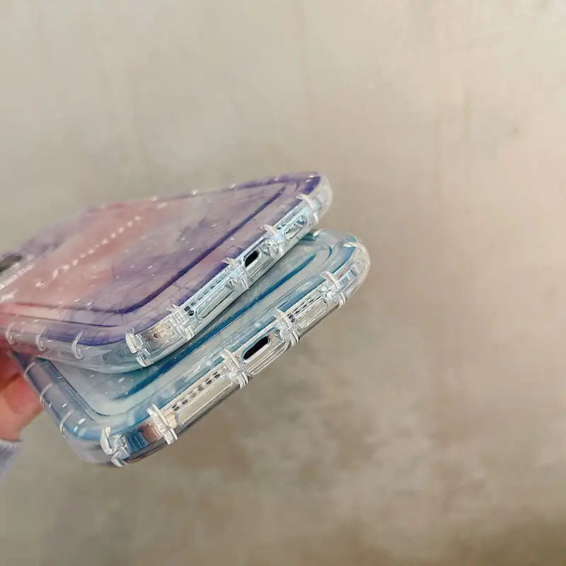 a hand holding a purple and blue case