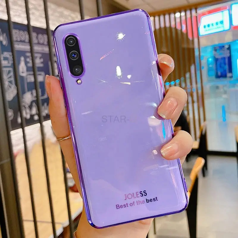 a person holding a purple iphone case