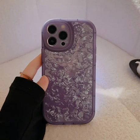 a person holding a purple phone case