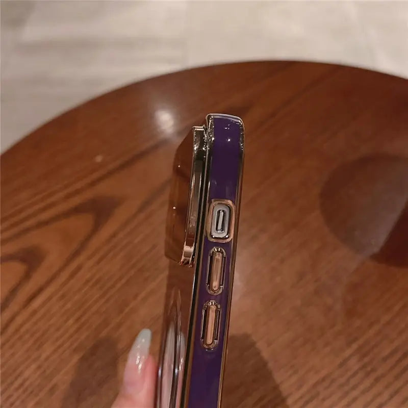 a person holding a purple pen with a pen in it