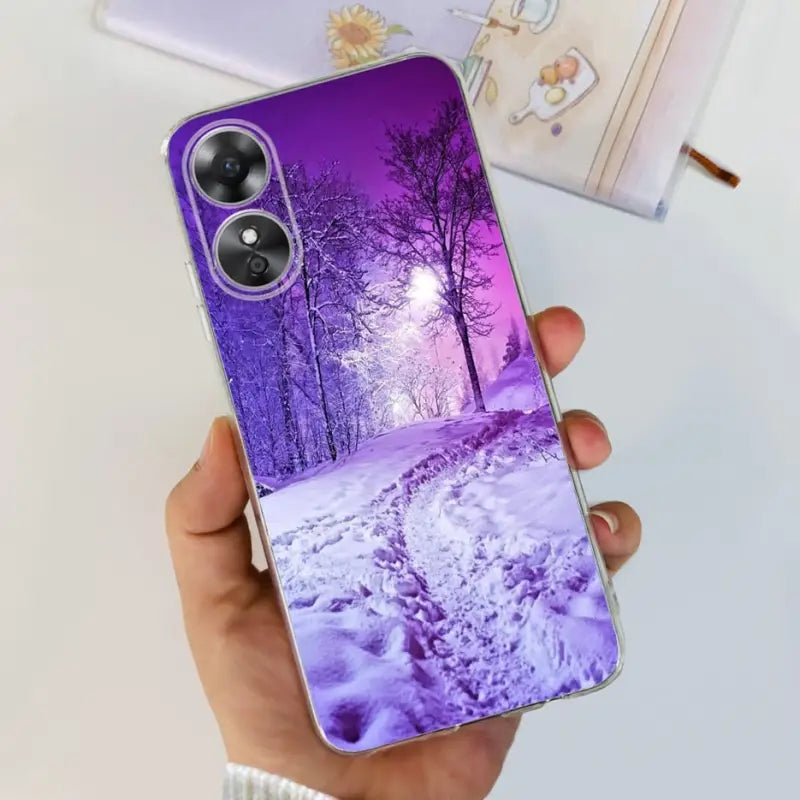 a person holding a purple phone case with a purple landscape