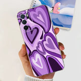 a person holding a purple phone case with a heart design