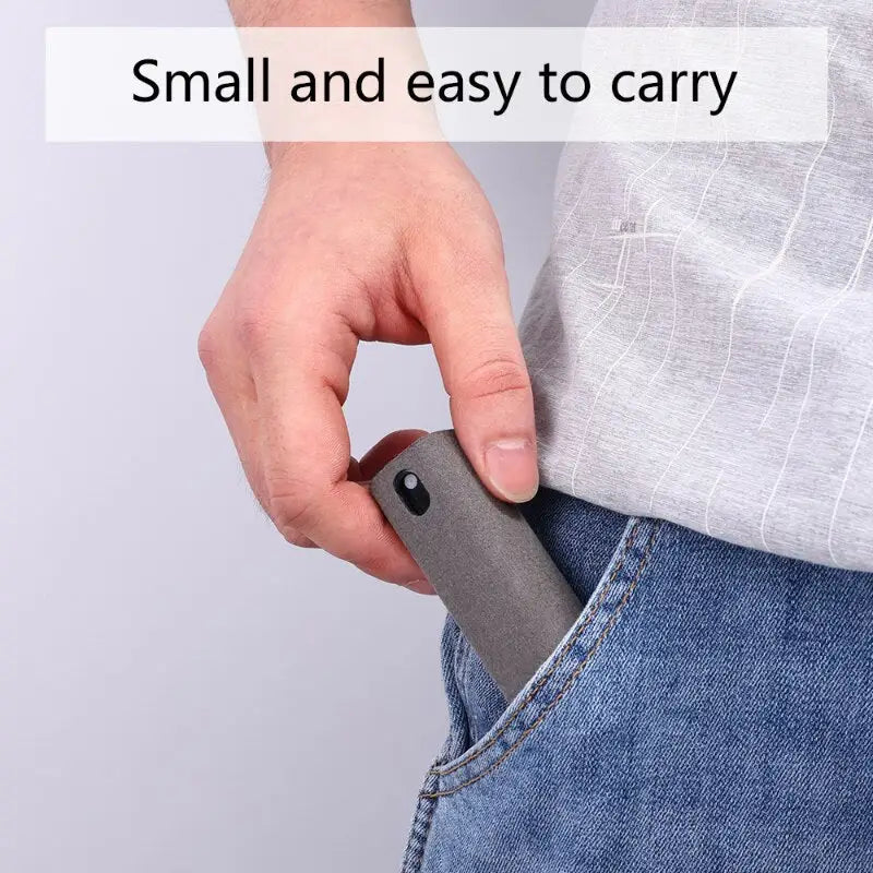 a person holding a small gray object in their pocket