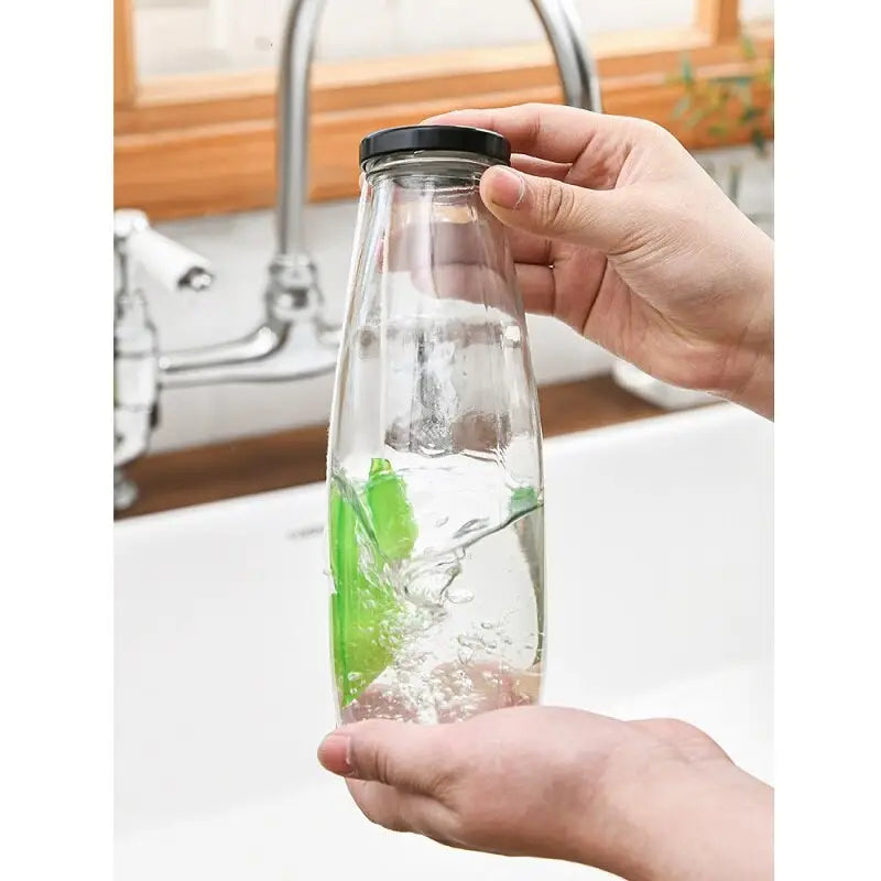 a person holding a water bottle with a green leaf inside