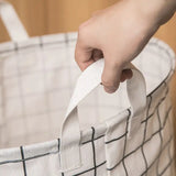 a person holding a white and black bag