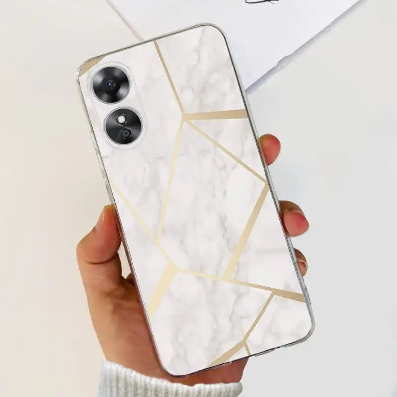a woman holding a white marble phone case with gold foil