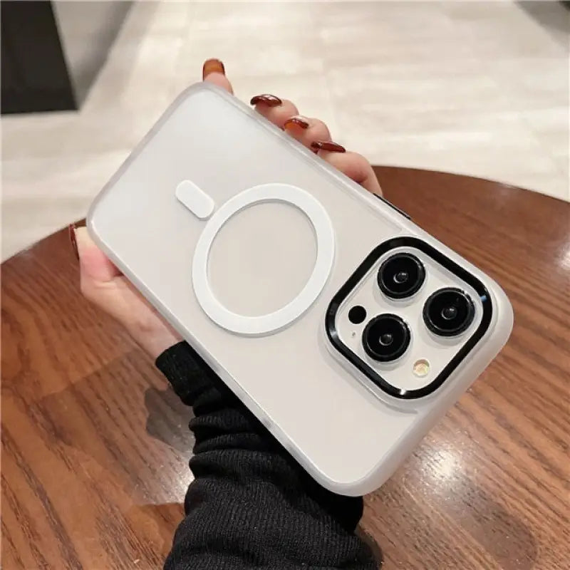 a person holding a white iphone case with a camera attached to it