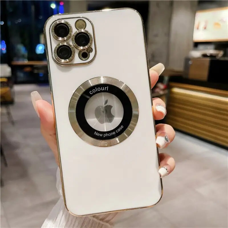 a woman holding a white iphone case with a camera