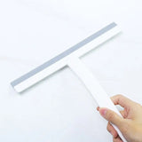 a hand holding a white plastic ruler