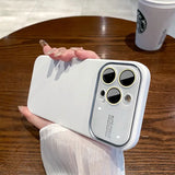a person holding a white phone with a white case