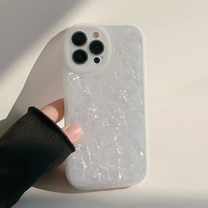a person holding a white phone case